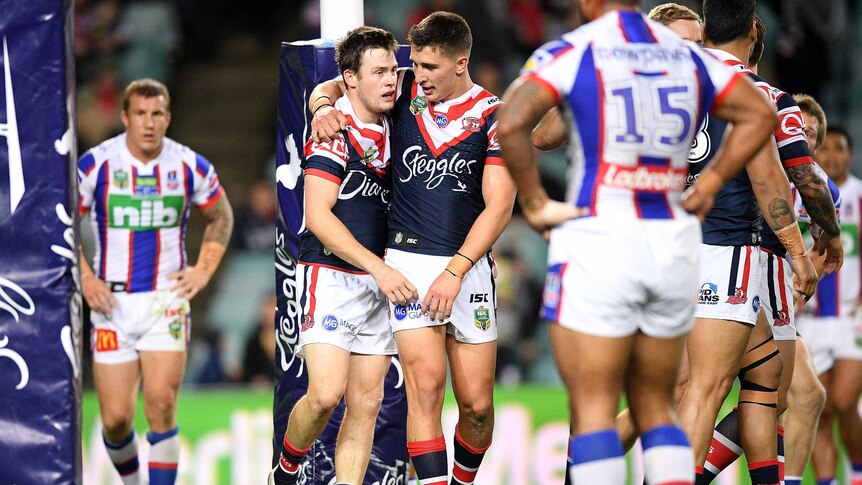 Luke Keary of the Roosters, (L), celebrates after scoring against Newcastle on July 21, 2017.