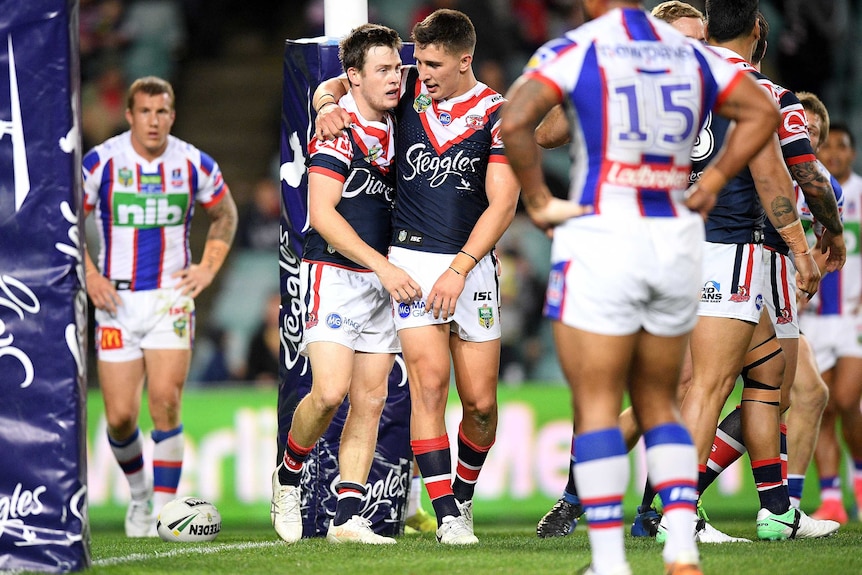 Luke Keary of the Roosters, (L), celebrates after scoring against Newcastle on July 21, 2017.
