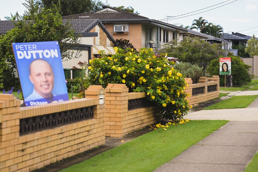 Corflute signs for Dickson LNP MP Peter Dutton and Ali France, Labor candidate in a street.