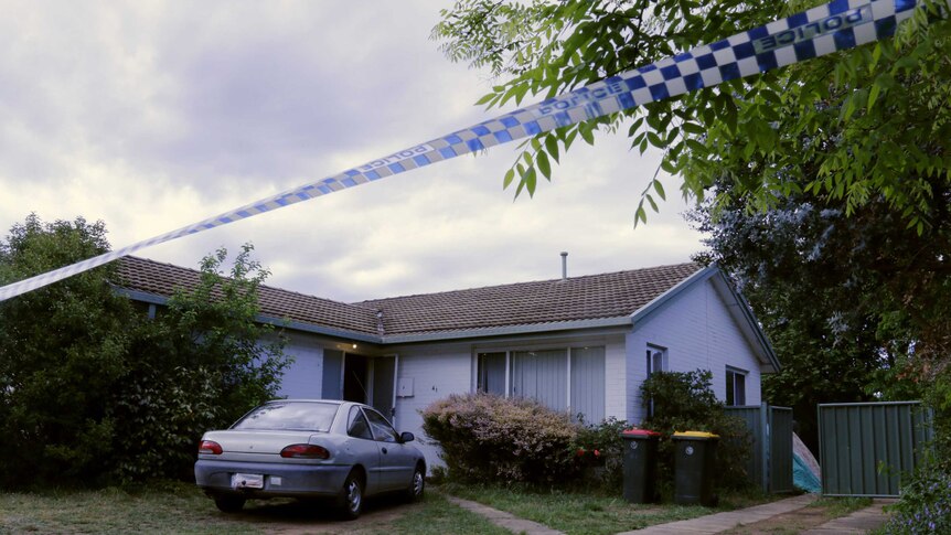 Police tape in front of a house.