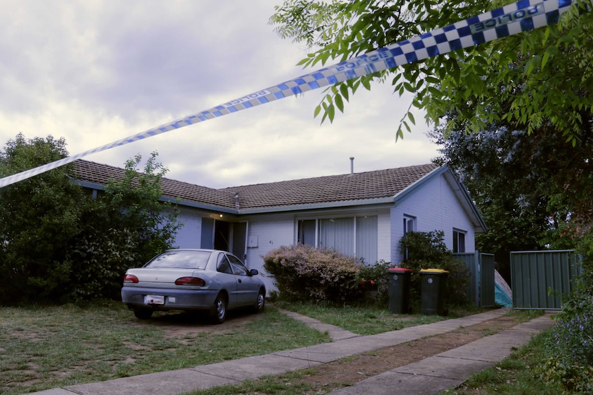 Police tape in front of a house.