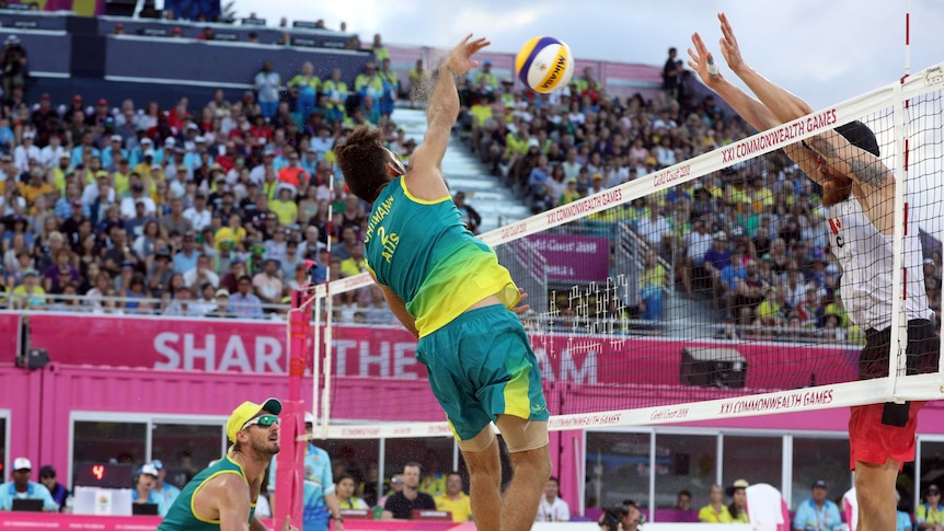 Australian volleyballer spikes against Canada.