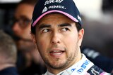 Sergio Perez is seen with his mouth slightly open and eyes looking to the left