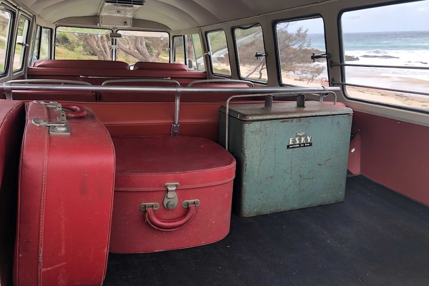 Vintage luggage sitting in the back of a Kombi bus
