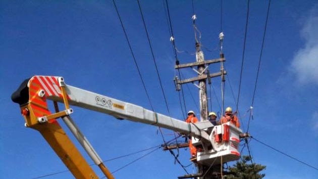 Country energy repair crews work on powerlines
