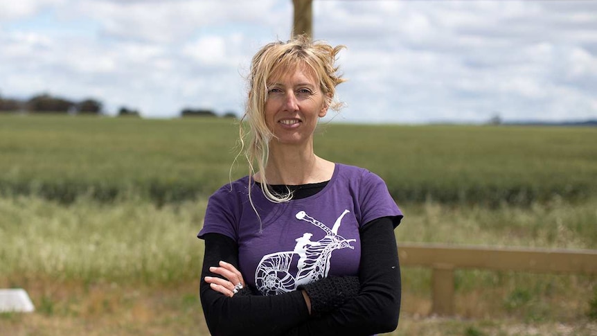 A woman stands in front of a landscape outside in western Victoria.