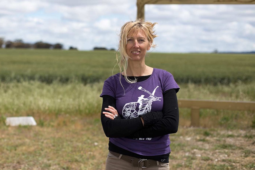 A woman stands in front of a landscape outside in western Victoria.