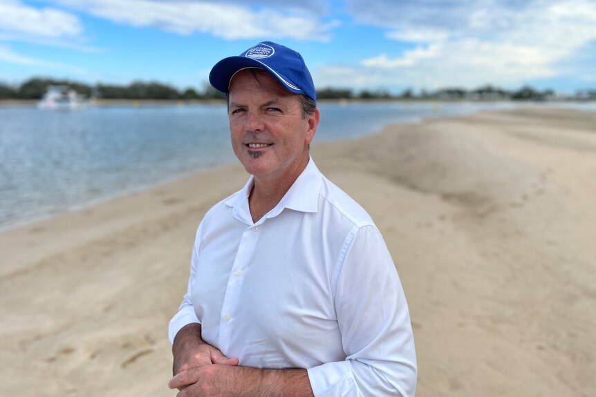 Chief executive officer standing on the shore of a bay at The Spit.