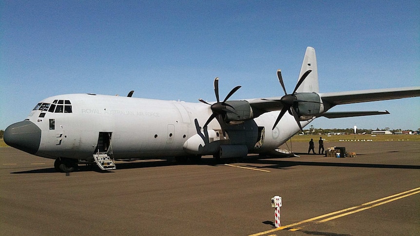 The first C130 Hercules aircraft arrives at Bundaberg airport with a medical evacuation team and supplies for the flooded city.