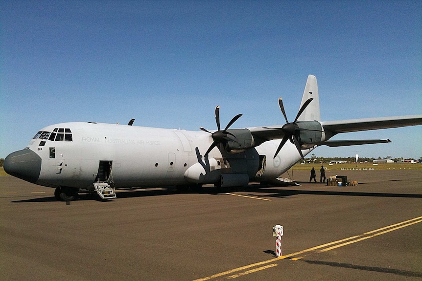 The first Hercules C-130 aircraft arrives at Bundaberg airport with a medical evacuation team and supplies for the flooded city.