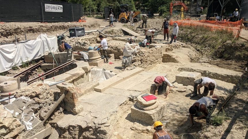 A group of archaeologists excavate a site