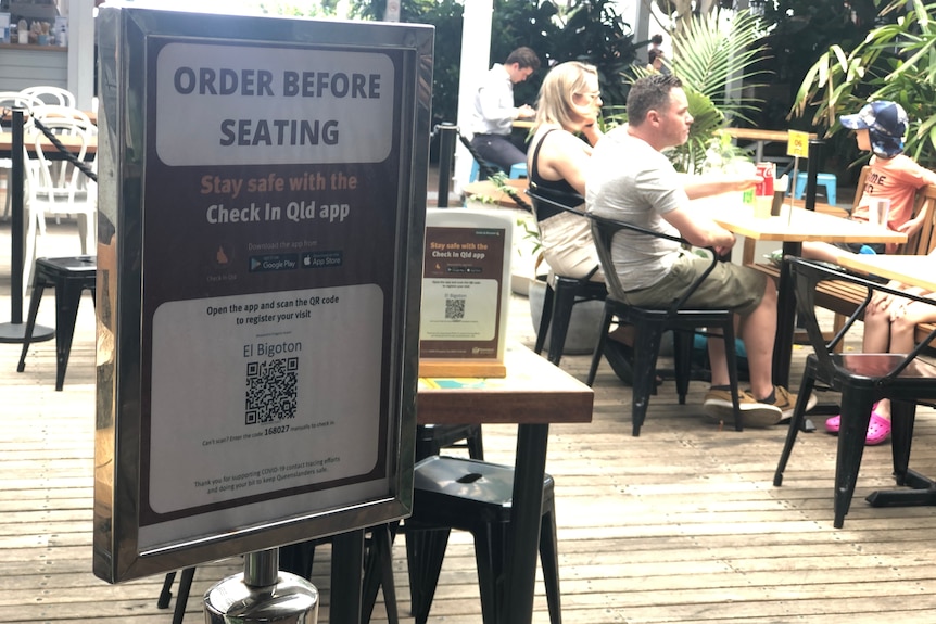 Queensland check in QR code with cafe diners in background