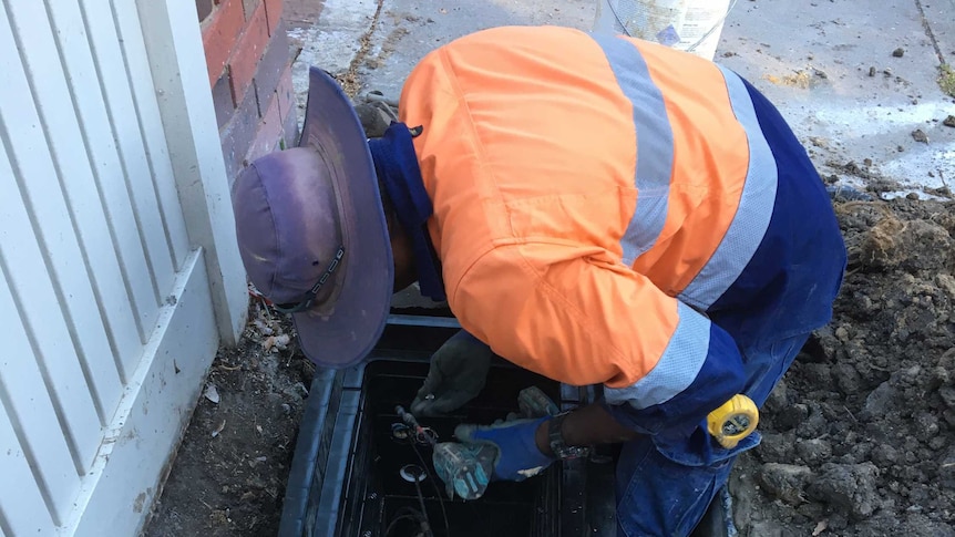 A Telstra worker in the pit used for Nicholas Gillett's NBN group connection.