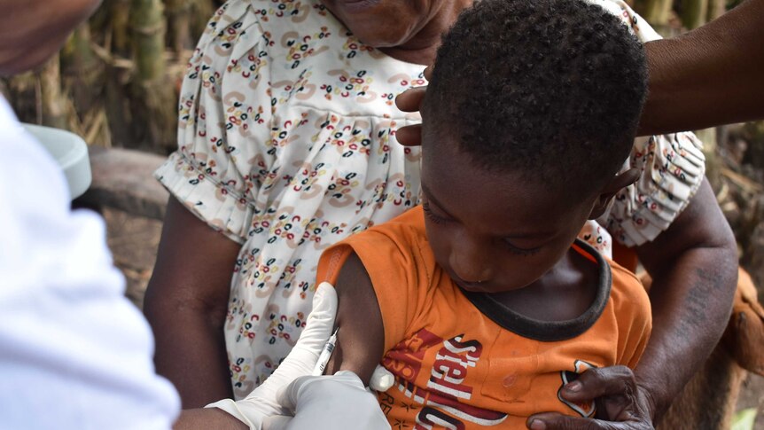 A boy receives a polio immunisation in Papua New Guinea