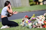 A friend of the victims named Korri Loader reacts at a makeshift shrine.