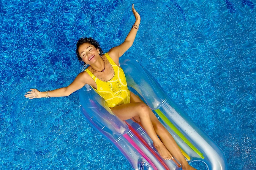 Woman lies on a float toy in the pool