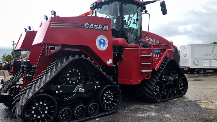 Big red tractor with quad track wheels