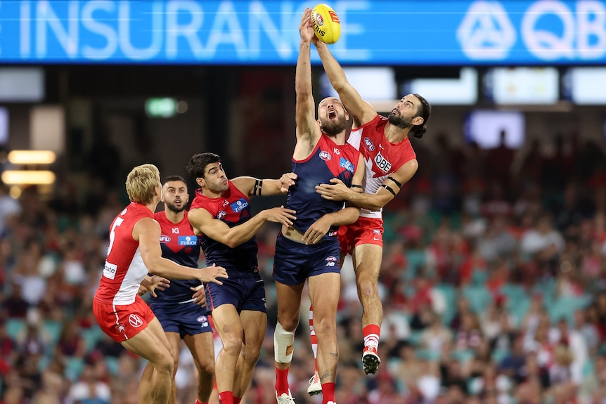 Max Gawn and Brodie Grundy compete in the ruck as midfielders wait for the tap