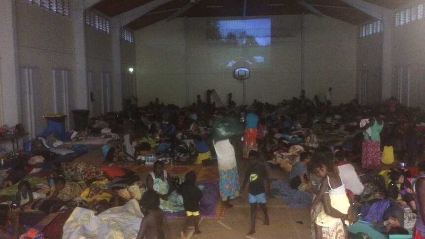 About 450 people watch movies inside a school as Elcho Island prepares for Cyclone Lam.