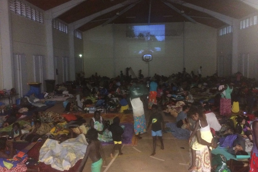 Families watch movies inside a school as Elcho Island prepares for Cyclone Lam.