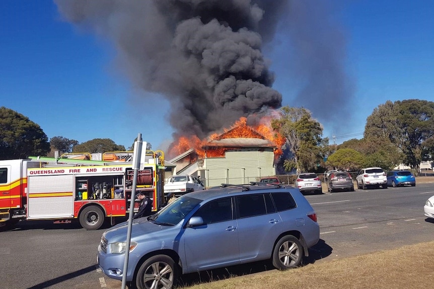 Firefighters and fire trucks try to put out fire at the Warwick East State School