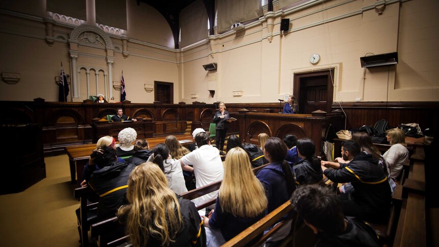 High school students take part in a courtroom drama as part of an education program