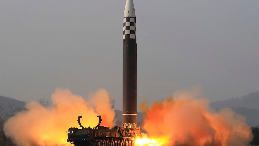 A large missile is seen taking off from the back of a truck