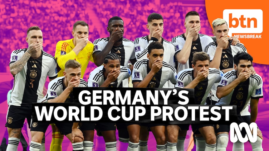 The eleven German players on the field for their team photo covering their mouths with one hand.