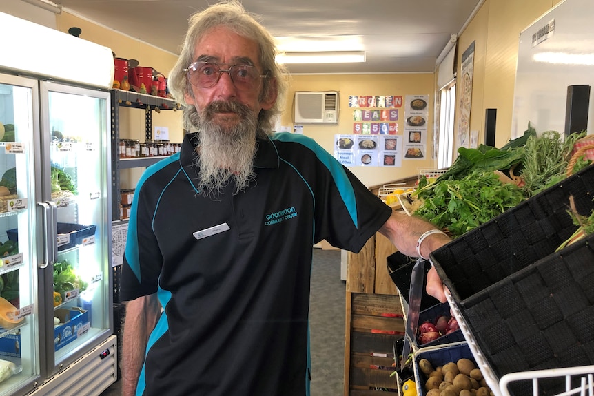 Wally Douglass standing next to fresh vegetables at the Waterbridge Food cooperative in Gagebrook, Tasmania