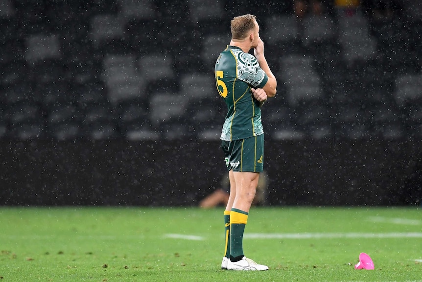 A Wallabies player stands holding his chin after missing a penalty goal attempt against the Pumas.