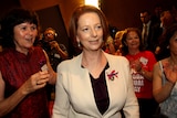 Prime Minister Julia Gillard as she is greeted at a forum of social and community workers in Sydney.
