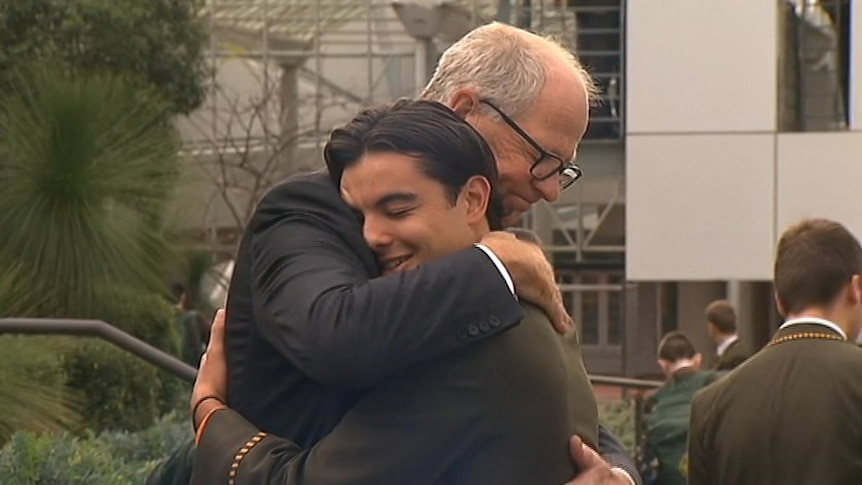 Rohan Brown hugs a student.