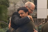 Rohan Brown hugs a student.