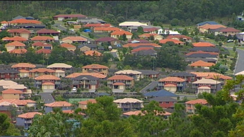 TV still of brick houses and streets in unidentified Brisbane estate in south-east Qld.