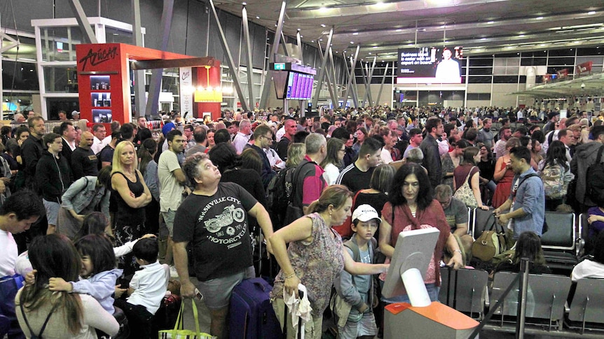 Crowds of people at the airport terminal.