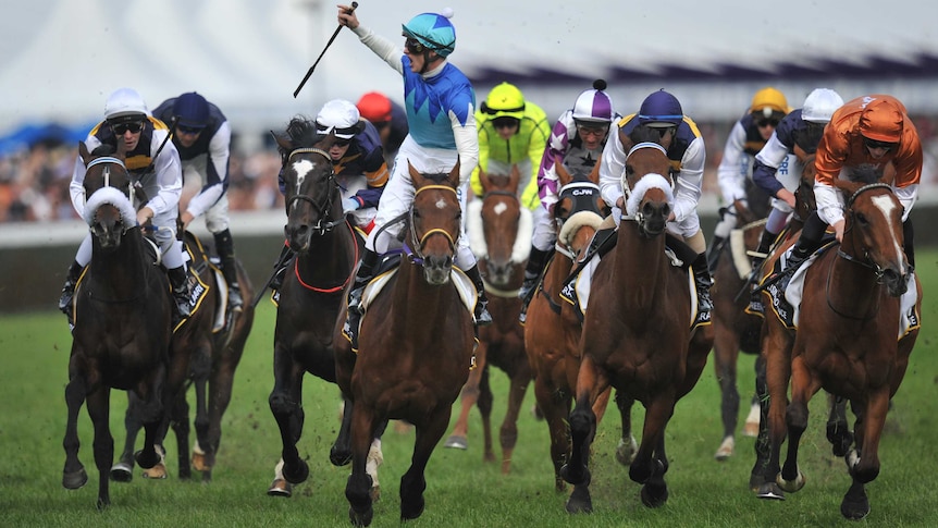 Jockey Zac Purton salutes the crowd after winning the Caulfield Cup on Admire Rakti