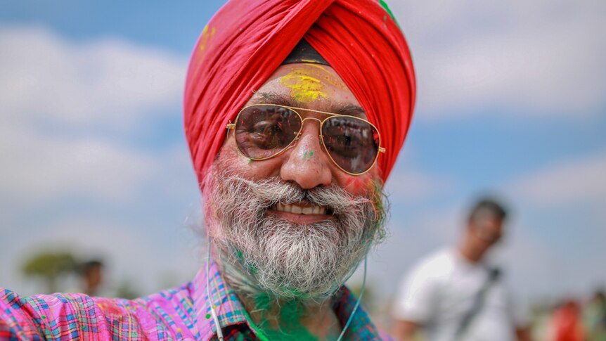 Guri Singh covered in coloured powder