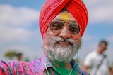 Guri Singh with coloured power all over his face, beard and clothes at a Holi festival in Melbourne.