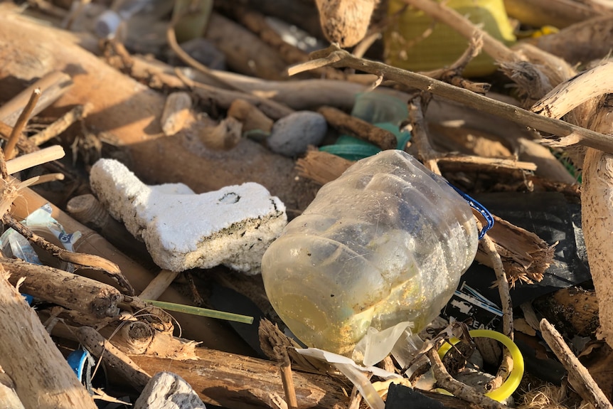 plastic water bottles and other marine debris on a beach on Christmas Island