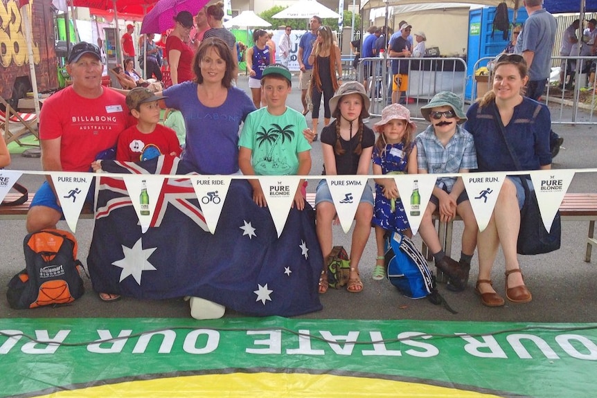 Families sit on the sidelines of the annual cockroach races in Brisbane.