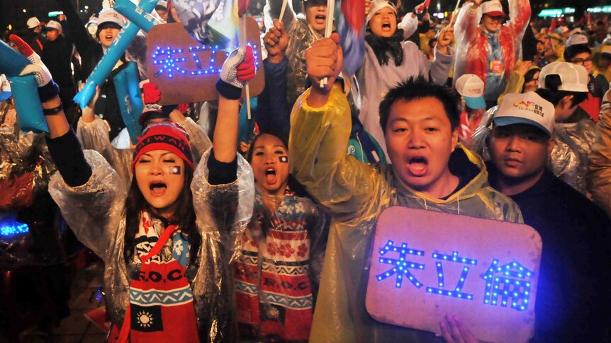 Supporters of Taiwanese presidential candidate Eric Chu chant slogans during a rally in New Taipei City.