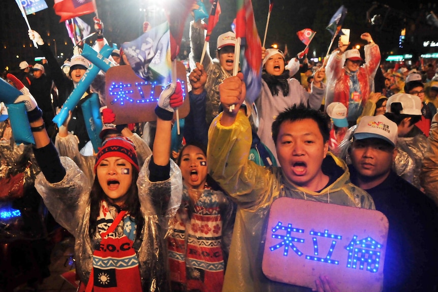 Supporters of Taiwanese presidential candidate Eric Chu chant slogans during a rally in New Taipei City.