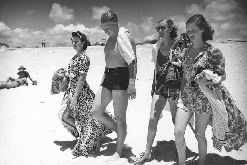 Four beachgoers in the 1940s