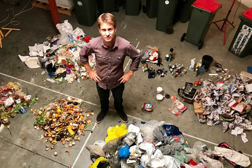 War on Waste Craig Reucassel amid piles of rubbish sorted during filming of the program.