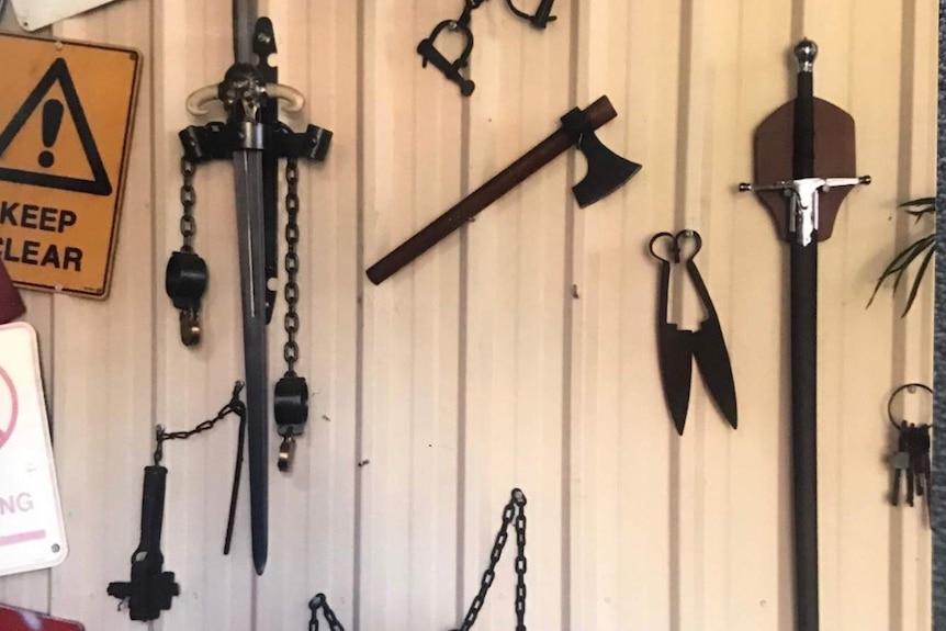 Weapons, including two swords, hanging in Vinzelberg's shed