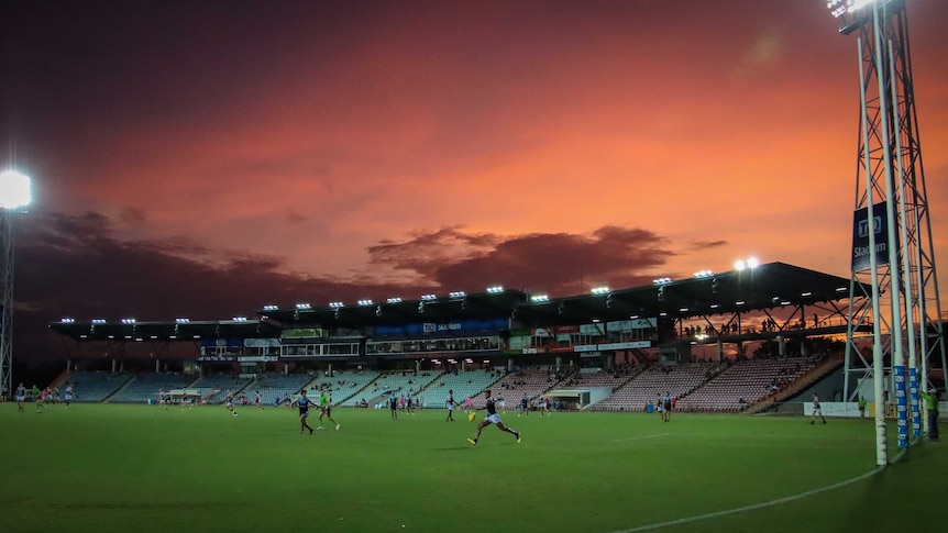 A match is seen being played at TIO Stadium during sunset.