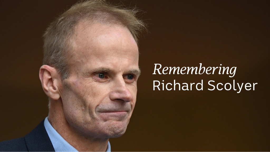 Richard Scolyer wears a blue collared shirt, close headshot, with text beside reaeding remembering Richard Scolyer
