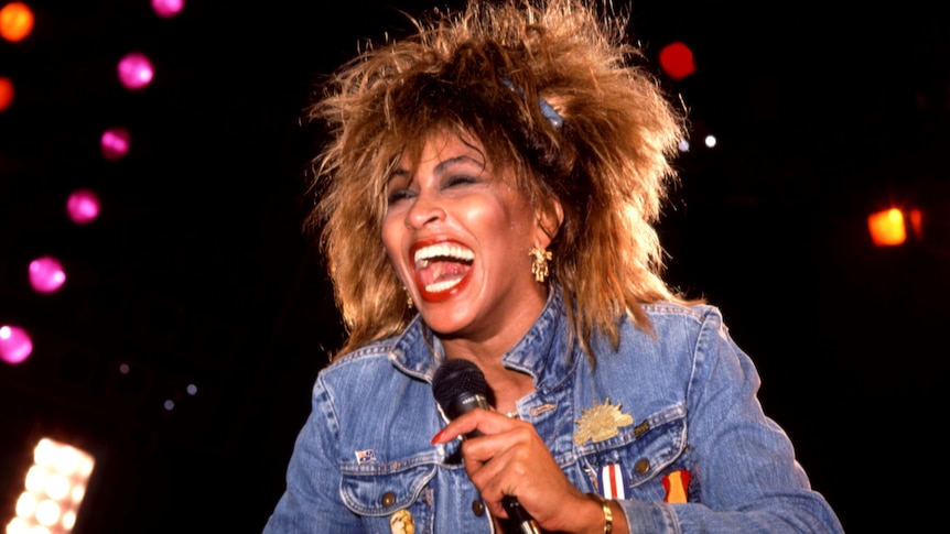 Tina Turner mic in hand performing in 1985