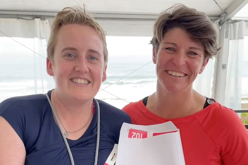 Two women holding a competitors bib, smiling. Ausnew Home Care, NDIS registered provider, My Aged Care