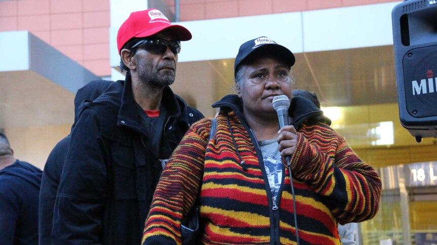 Colin and Nikoa Chatfield address the crowd at a rally after the death of their son Tane in custody.